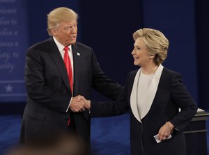 Republican presidential nominee Donald Trump shakes hands with Democratic presidential nominee Hillary Clinton following the second presidential debate at Washington University in St. Louis, Sunday, Oct. 9, 2016.