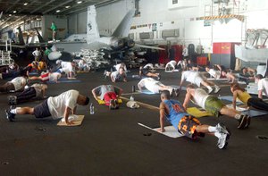 The Arabian Gulf (Mar. 17, 2003) -- Sailors participate in a workout led by the ship’s Explosive Ordnance Disposal (EOD) team in the hanger bay aboard the aircraft carrier USS Abraham Lincoln (CVN 72).