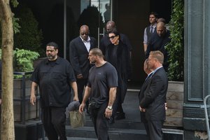 Kris Jenner is surrounded by security as she leaves the New York residence where her daughter Kim Kardashian West is staying, Monday, Oct. 3, 2016.