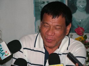 Davao City Mayor Rodrigo Duterte answers questions from reporters during a press conference at the Roman Catholic Cemetery in Davao City, Philippines.