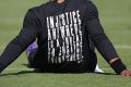 Carolina Panthers' Cam Newton wears a shirt with a quote by Martin Luther King as he warms up.