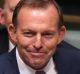 Former prime minister Tony Abbott responds to opposition cheers as he rises to ask a question on trade with Singapore ...