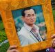 Thais hold portraits of King Bhumibol Adulyadej at Siriraj Hospital where the king is being treated in Bangkok.