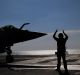 A Rafale jet fighter leaves France's flagship Charles de Gaulle aircraft carrier to join the US-led coalition against IS.