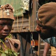 Idris Elba plays the leader of an African militia that takes in a boy played by Abraham Attah and teaches him to be a soldier in the Netflix film, “Beasts of No Nation.” – Photo: Netflix