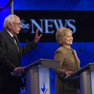 Sen. Bernie Sanders speaks as former Secretary of State Hillary Clinton smiles during an ABC News debate in December. – Photo: Disney, ABC