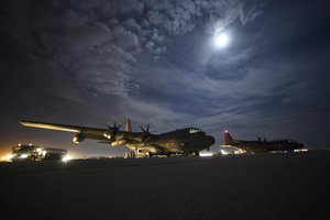 Two HC-130J Combat King II aircraft sit on the flightline awaiting cargo unloading on Diyarbakir Air Base in Turkey, Sept. 28, 2015.