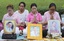 Thais pray behind portraits of Thailand's King Bhumibol Adulyadej at Siriraj Hospital where the king is being treated in Bangkok, Thailand, Wednesday, Oct. 12, 2016.