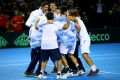 Party time: Leonardo Mayer is mobbed by his Argentina teammates as they secured a spot in the Davis Cup final.