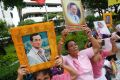 Thais hold portraits of King Bhumibol Adulyadej at Siriraj Hospital where the king is being treated in Bangkok.