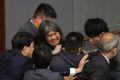 Lawmaker Leung Kwok-hung, known as "Long Hair",  tries to break through the security guards during the election of ...