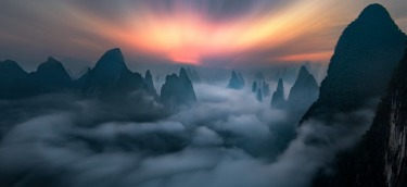 This was taken at the break of dawn on a mountain top in Guilin, China. On a fine day, one can see the city that ...