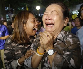 Thai cry at Siriraj Hospital where the king is being treated in Bangkok, Thailand, Thursday, Oct. 13, 2016.