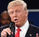 Republican presidential nominee Donald Trump speaks Democratic presidential nominee Hillary Clinton listens during the ...