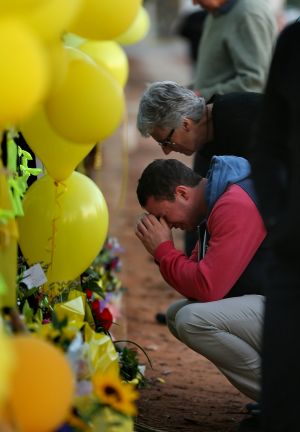 Stephanie Scott's mother Merrilyn Scott and her fiance Aaron Leeson-Woolley outside a makeshift memorial at Leeton High ...