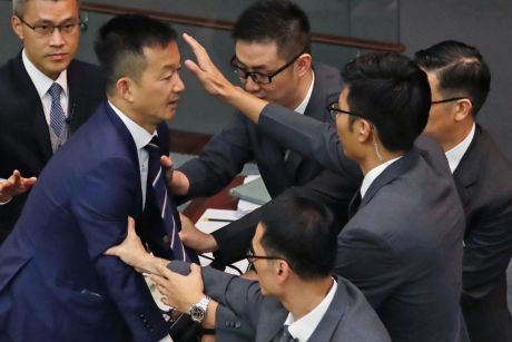 Lawmaker Raymond Chan Chi-chuen tries to break through the security guards during the election of president of the ...