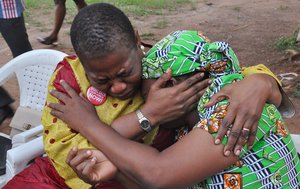 "Bring Back Our Girls" co-founder Obiageli Ezekwesili, left, console Esther Yakubu, mother of one of the kidnapped school girls, after she saw her daughter in a video release by Boko haram during a briefing in Abuja, Nigeria. Sunday Aug. 14, 2016 .