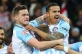 Tim Cahill and teammates celebrate a City goal during the FFA Cup.