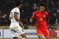 South Korea's Koo Ja Cheol (right) tries to dribble past Iran's Vahid Amiri during their World Cup group A qualifying match.