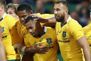 Finding form at last: Will Genia and the Wallabies celebrate a try in Perth as Australia recorded their best win of the year.