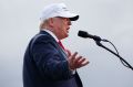 Opting for the white hat, Republican presidential candidate Donald Trump speaks during a campaign rally.