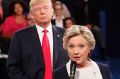 Donald Trump "towered behind" Hillary Clinton as she answered some questions during the second debate.