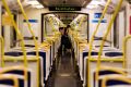 A cleaner clears the mess on a train bound for the city from Sandringham.