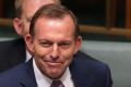 Former prime minister Tony Abbott responds to opposition cheers as he rises to ask a question on trade with Singapore ...
