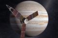 The Juno spacecraft passes in front of Jupiter in this artist's depiction. 