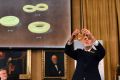 Professor Thors Hans Hansson gives a demonstration after revealing the winners of the Nobel prize in physics in Stockholm.