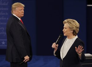 Republican presidential nominee Donald Trump listens to Democratic presidential nominee Hillary Clinton during the second presidential debate at Washington University in St. Louis, Sunday, Oct. 9, 2016.