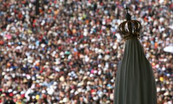 The statue of Our Lady of Fatima overlooks worshippers at the Fatima shrine (AP)