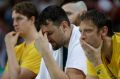 Shock defeat: Andrew Bogut reacts with teammates on the bench.