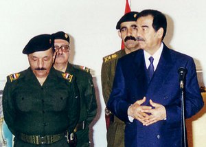 In this Tuesday, Feb. 11, 2003 file photo, Iraqi President Saddam Hussein meets with his leadership to mark the first day of Eid Al-Adha, the biggest feast of the Muslim calendar in Baghdad, Iraq.