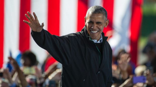 Welcome: President Obama walks to the podium at a campaign rally for Clinton on Friday.