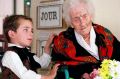 Thomas, 5, looks at Jeanne Calment after he brought her flowers at her retirement home in Arles, southern France. ...