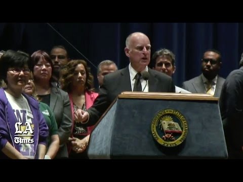 Gov. Jerry Brown signs the $15-per-hour minimum wage bill