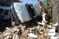 A car stands on its side after being blown away by winds brought by Hurricane Matthew in Jeremie, Haiti.