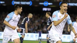 Cometh the hour: Tim Cahill races towards the corner flag for his trademark celebration after his wonder strike.