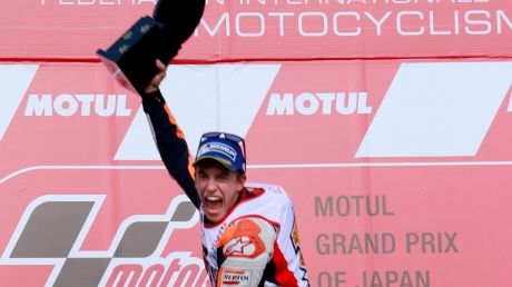 Full throttle: Spain's Marc Marquez jumps for joy after securing the 2016 MotoGP world title.