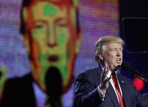 Republican presidential candidate Donald Trump is seen on a large screen as he speaks during a charity event hosted by the Republican Hindu Coalition, Saturday, Oct. 15, 2016, in Edison, New Jersey.