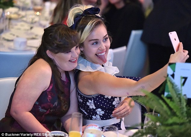 There it is!: The former Disney star did her signature tongue pose as she posed with American Horror Story star Jamie Brewer