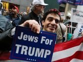 A supporter of Donald Trump, holding a sign that reads "Jews for Trump," stand outside Trump Tower in New York, October 8, 2016.