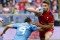 Rhys Webb of Wales is tackled by Edoardo Gori.