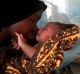 Mariam Kasim, a refugee from the Democratic Republic of Congo carries her one day old baby Sarah Bonamaxi at the ...