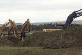 Excavators are in place as work resumed Tuesday, Oct. 11, 2016, on the four-state Dakota Access pipeline near St. Anthony, N.D. A federal appeals court ruling on Sunday cleared the way for work to resume on private land in North Dakota that's near a camp where thousands of protesters supporting tribal rights have gathered for months.