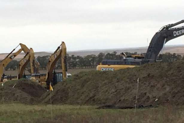 Excavators are in place as work resumed Tuesday, Oct. 11, 2016, on the four-state Dakota Access pipeline near St. Anthony, N.D. A federal appeals court ruling on Sunday cleared the way for work to resume on private land in North Dakota that's near a camp where thousands of protesters supporting tribal rights have gathered for months.