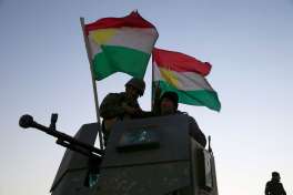 Kurdish Peshmerga fighters stand on top of a military vehicle as they advance towards villages surrounding Mosul, in Khazer, about 30 kilometers (19 miles) east of Mosul, Iraq, Monday, Oct. 17, 2016. The Iraqi military and the country's Kurdish forces say they launched operations to the south and east of militant-held Mosul early Monday morning.