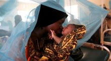 Mariam Kasim, a refugee from the Democratic Republic of Congo carries her one day old baby Sarah Bonamaxi at the ...