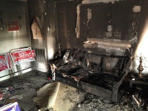 A burnt couch is shown next to campaign signs at the Orange County Republican Headquarters in Hillsborough, NC on October 16 2016.